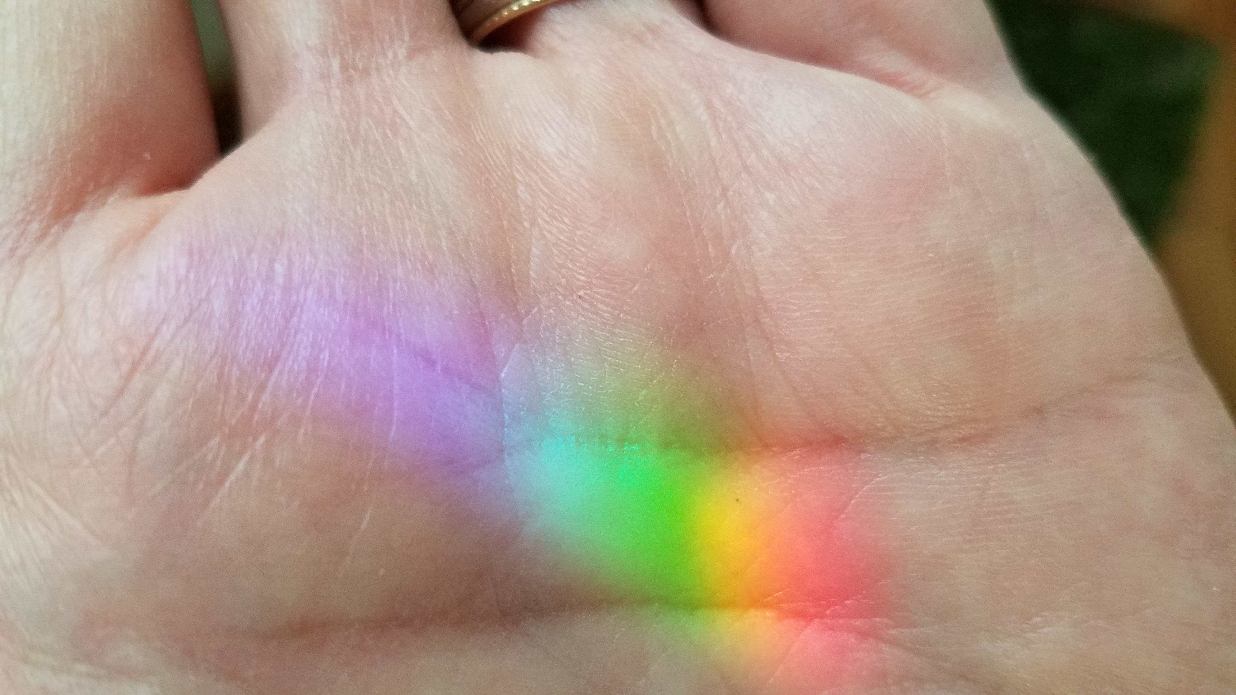 rainbow on palm of hand